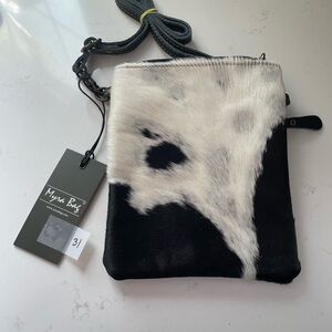 Black and white cross body bag. Cowhide